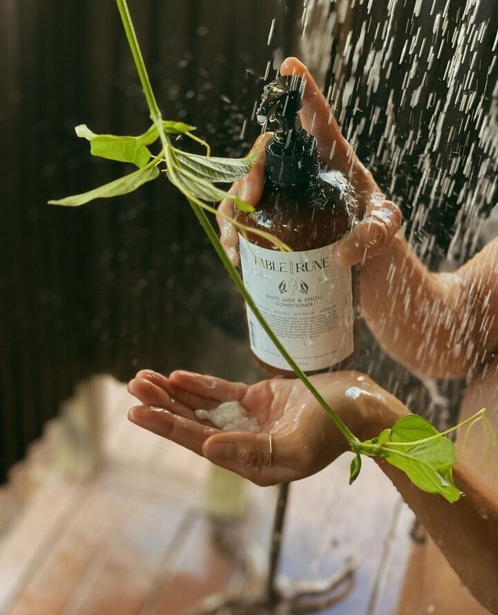 Hands rinsing with product under water